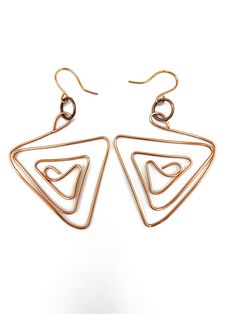 An original geometric pair of earrings. Copper wire has been hand shaped into a bold freeform design. These 2-1/2 inch wide earrings dangle 2-3/4 inches from handmade copper fish hooks. The shiny lightweight wire makes them comfortable to wear. An inventive creative pair of earrings that are truly unique and one of a kind. A perfect gift for the lady who loves to be different. Fish Hooks, Earring Gift, Design Earrings, Hand Shapes, Handmade Copper, Large Earrings, Copper Earrings, Earrings Dangle, Copper Wire