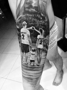 a man with a tattoo on his leg that has an image of two people holding hands