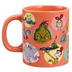 an orange coffee mug with cartoon characters on it