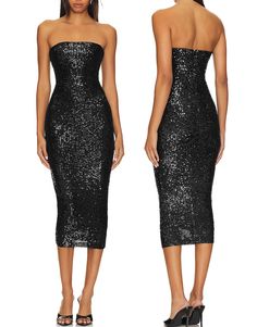 a woman wearing a black dress with sequins on the side and back,