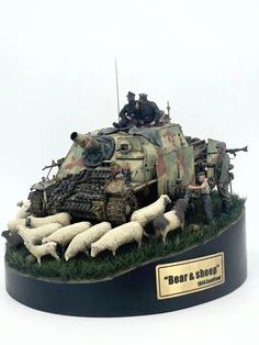 a group of men on top of a tank with sheep