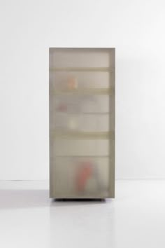 an abstract photograph of a shelf with shelves on it's sides, in front of a white wall