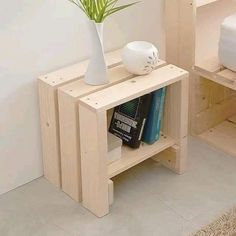 a white vase sitting on top of a wooden shelf next to a bed and nightstand