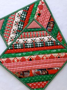 a quilted christmas ornament with red, green and white designs