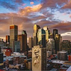 a city skyline with tall buildings and a painting of a man in a hat on the side