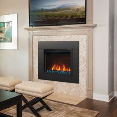 a living room with a fireplace and television mounted above the fire place in the wall