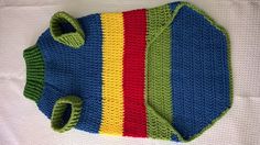 a crocheted bag is laying on a white surface with a green, yellow, and red stripe