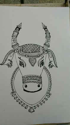 a drawing of a cow's head is shown on a piece of white paper