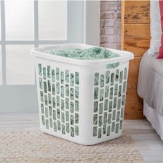 a white laundry basket sitting on top of a rug