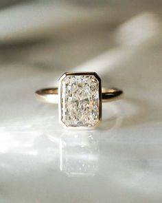 a diamond ring sitting on top of a table