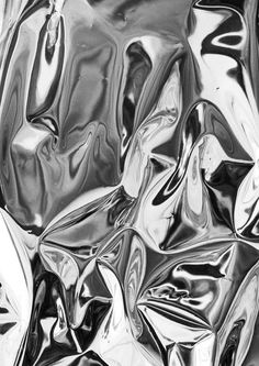 an abstract black and white photo of shiny material, like foil or plastic sheeting