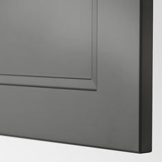 a close up view of the corner of a wall with a black frame on it