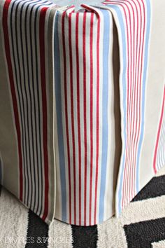 a red, white and blue striped gift wrapper sitting on top of a rug