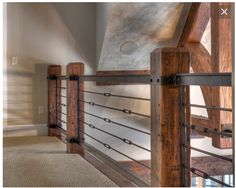 an empty room with wood and metal railings