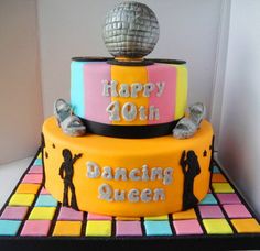 a birthday cake decorated with disco balls and the words happy 90th dancing queen on top