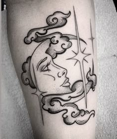 a black and white tattoo on the leg of a person with a sun behind her head