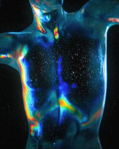 an abstract image of a man's torso and back with multicolored paint on it