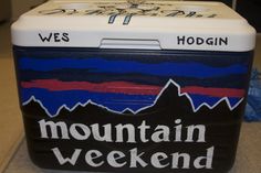 a cooler with the words mountain weekend written on it