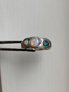 Gorgeous aussie opals containing all the colors and glitter of the universe  Set in sterling silver. Made using the lost wax method, for that chunky look 👀  Size 54 mm circumference, 17 mm diameter, 17 DE, 7 US, N UK Can be sized up Handmade Silver Multi-stone Opal Ring As Gift, Unique Ethiopian Opal Ring, Iridescent Opal Ring With Unique Style, Silver Multi-stone Ethiopian Opal Jewelry, Unique Iridescent Round Opal Ring, Artisan Silver Opal Ring, Iridescent Opal Ring In Sterling Silver For Anniversary, Multi-stone Sterling Silver Opal Ring, Unique Hallmarked Sterling Silver Opal Ring