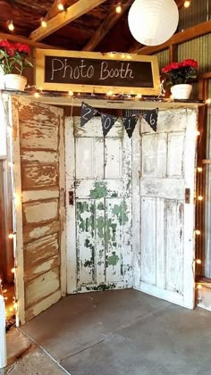 an old door is decorated with lights and potted plants