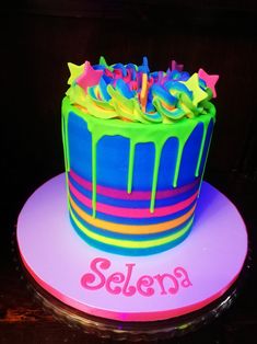 a birthday cake with neon colors and stars on it