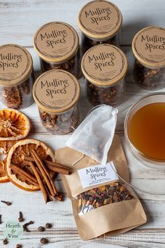 an assortment of mulling spices next to some sliced oranges