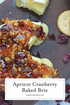 apricot cranberry baked brie on a cutting board with crackers