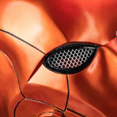 a close up of an orange car's grille