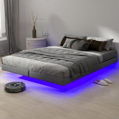 a bed that has some lights on the side of it and is in front of a window