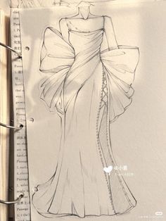 a drawing of a woman's dress is shown on a piece of paper next to some scissors