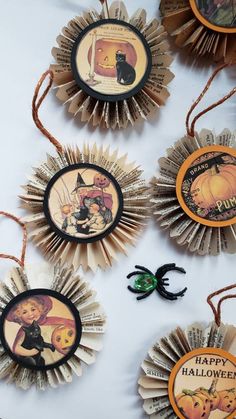 halloween decorations made out of book pages on a white table with pumpkins and jack - o'- lanterns