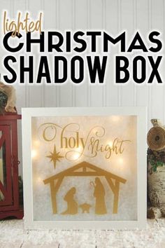 the lighted christmas shadow box is next to a nativity scene