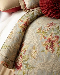 the comforter is made up with red and green pillows