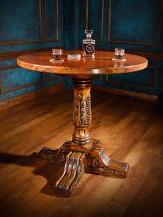 a wooden table sitting on top of a hard wood floor next to a blue wall