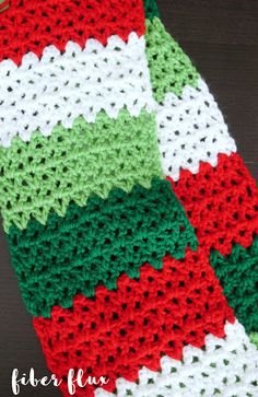 the crocheted scarf is red, white and green