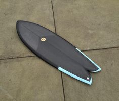 a blue and black surfboard laying on the ground