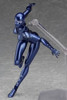 a toy figure is posed on a clear base with one arm extended and the other leg bent