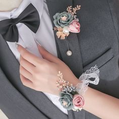 a close up of a person wearing a suit and tie with flowers on the lapel