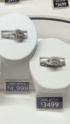 three engagement rings are on display for sale