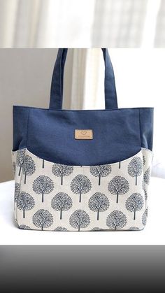 a blue and white bag with trees on it