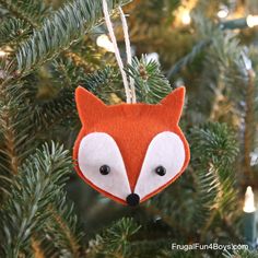 a red fox ornament hanging from a christmas tree