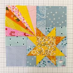 a patchwork quilt with many different colors and patterns on it, including one star