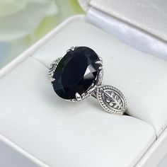 Black Onyx Ring (Natural or Black CZ) Dragon Design#133 Made To Order    This lovely sterling silver filigree ring is set with a stunning black gemstone (please choose between Natural Onyx or Black CZ). The oval-cut faceted gemstone is 14mm x 10mm. The ring is 8mm off the finger. Notice the detailed design of the silver filigree setting and band. This is an exquisite rendition of a Gothic ring. The Renaissance filigree has amazing elegance.  Ornate claw-style prongs grasp the oval stone tightly.  Dangerously beautiful, the Dragon design has curves that create a graceful silhouette.  Suggested retail $169-$279 SHOP now and indulge in exquisite vintage reproduction jewelry.  OUR ETSY Shop: https://silverembracejewelry.etsy.com *Custom Made to Order: Please allow 15 business days for creation Gothic Ring, Nature Ring, Gothic Rings, Black Onyx Ring, Onyx Gemstone, Detailed Design, Sterling Silver Filigree, Cubic Zirconia Rings, Dragon Design