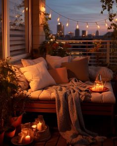 a balcony with candles and blankets on it