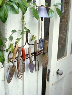 garden tools hanging from the side of a door