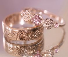 three wedding rings with pink stones on them