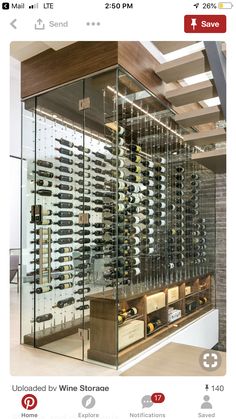 a wine cellar filled with lots of bottles and glasses on the wall next to stairs