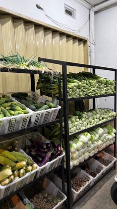 an assortment of vegetables are on display in the store's vegetable section, including leeks, onions, and snap peas