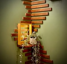 a vase with flowers sitting on top of a wooden shelf