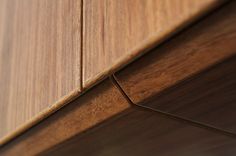 the corner of a wooden cabinet with wood grains